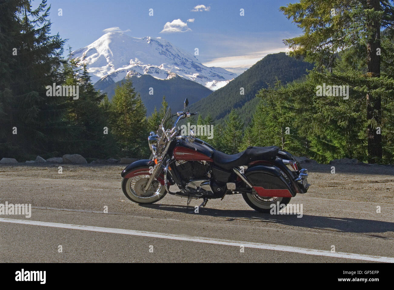 A motorcycle is parked at a roadside pullout on Scenic 410, going through Mount Rainer National Park in Washington State, USA. Stock Photo