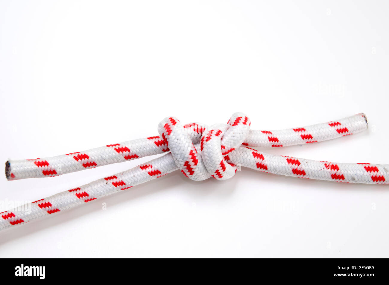 The True Lovers, or Fisherman's Knot on white background used to join two lengths of rope with two overhand (granny) knots one o Stock Photo