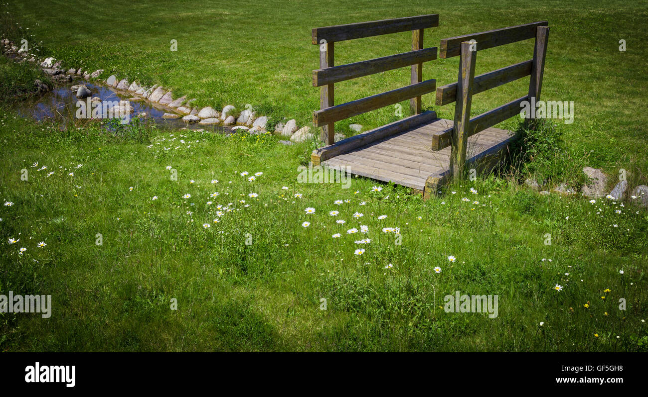 Old wooden bridge in the park, with small stream Stock Photo - Alamy