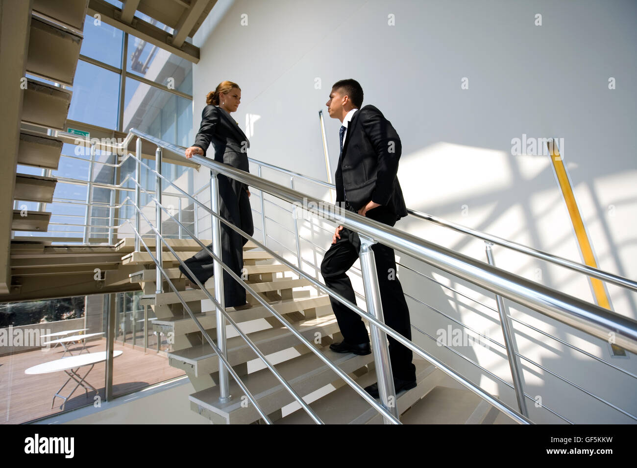 Two business personnels on the stairs. Stock Photo