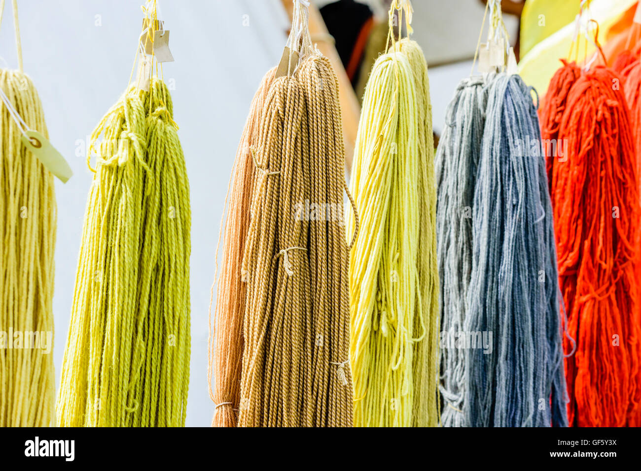 Yarn White Rope Look In Hand dyed yarn hanging from ropes with white tent in background Stock ...