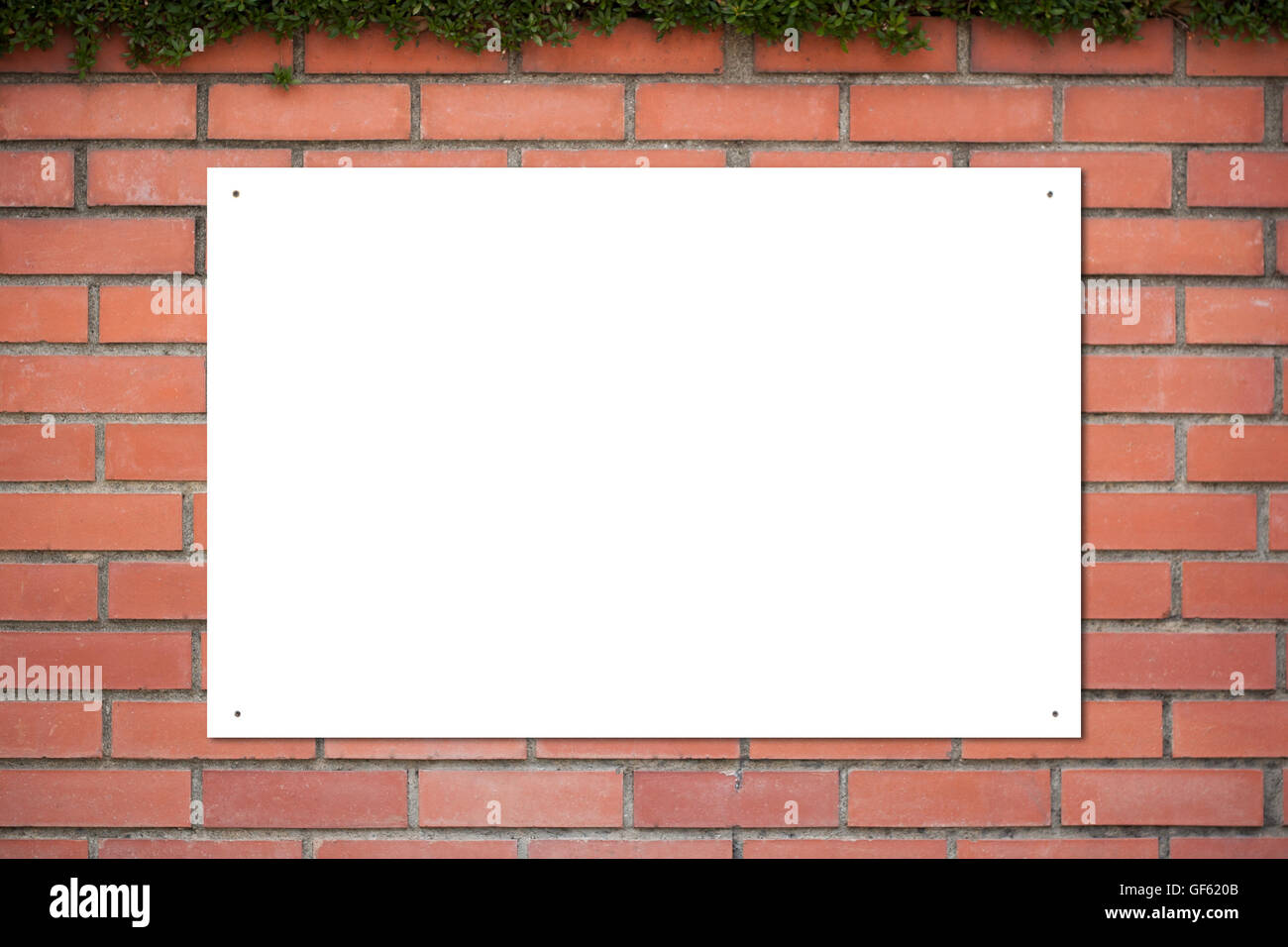 Empty white sign board frame on bricks wall Stock Photo