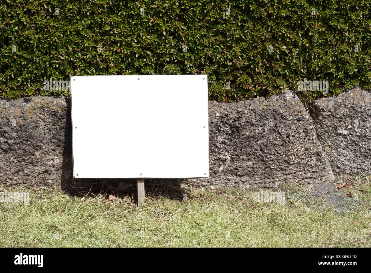 Empty white sign board frame in the lawn yard Stock Photo