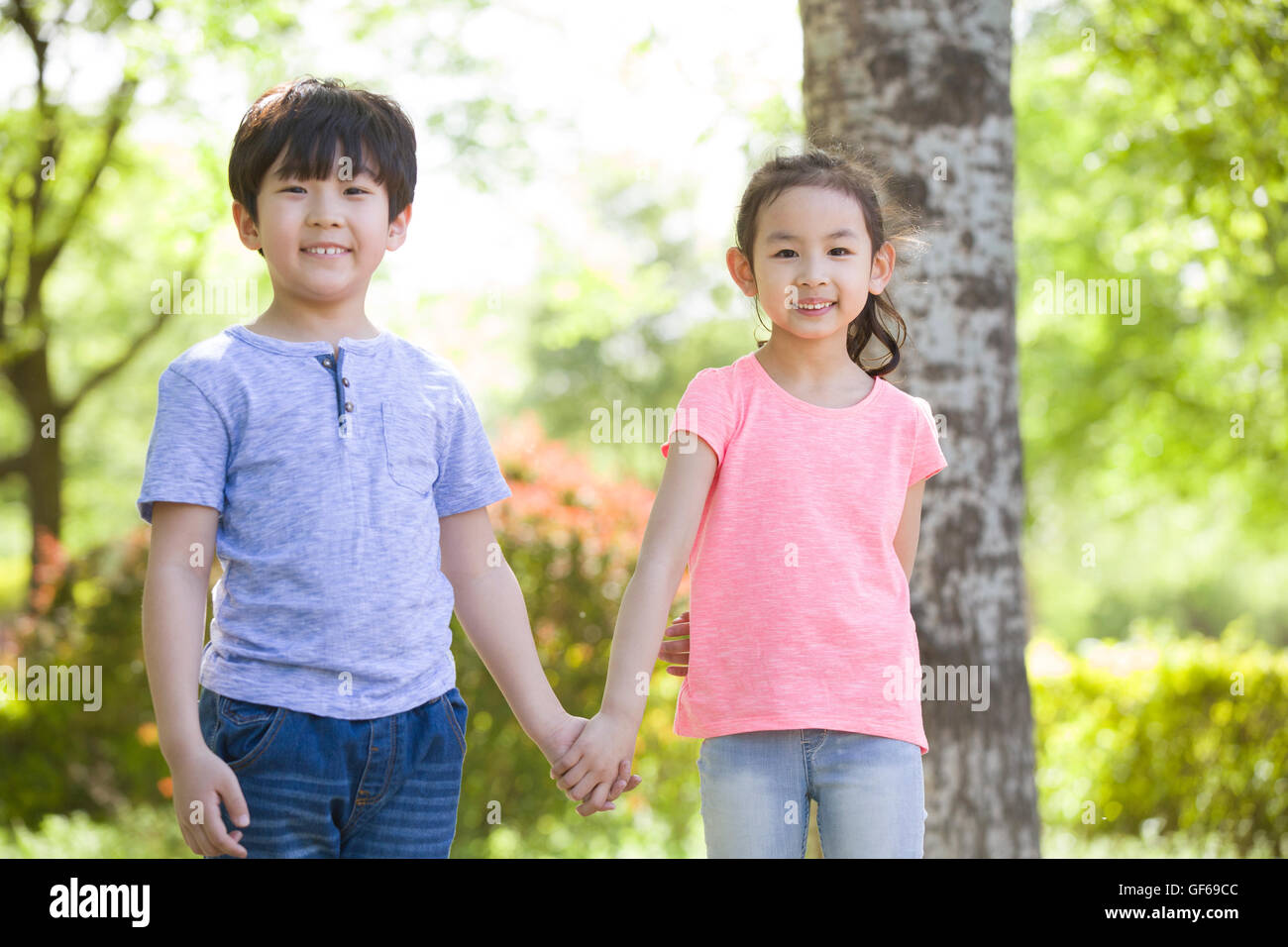 Portrait of happy Chinese children in woods Stock Photo - Alamy