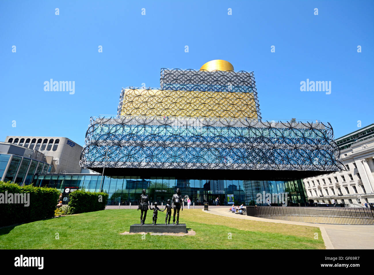 The Library of Birmingham with A Real Birmingham Family statue in the foreground in Centenary Square, Birmingham, England, UK. Stock Photo