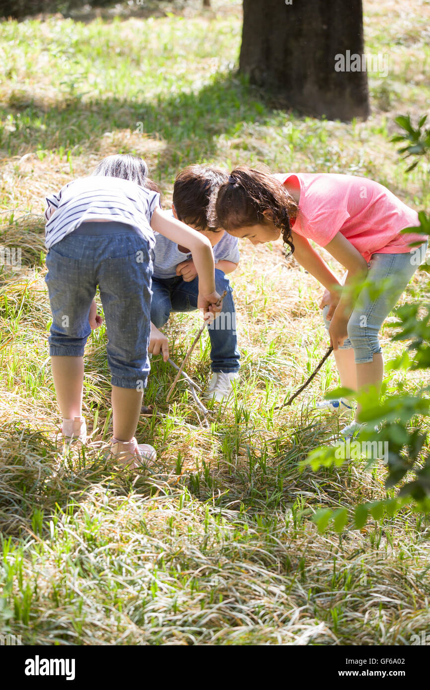 Happy Chinese children playing in woods Stock Photo - Alamy