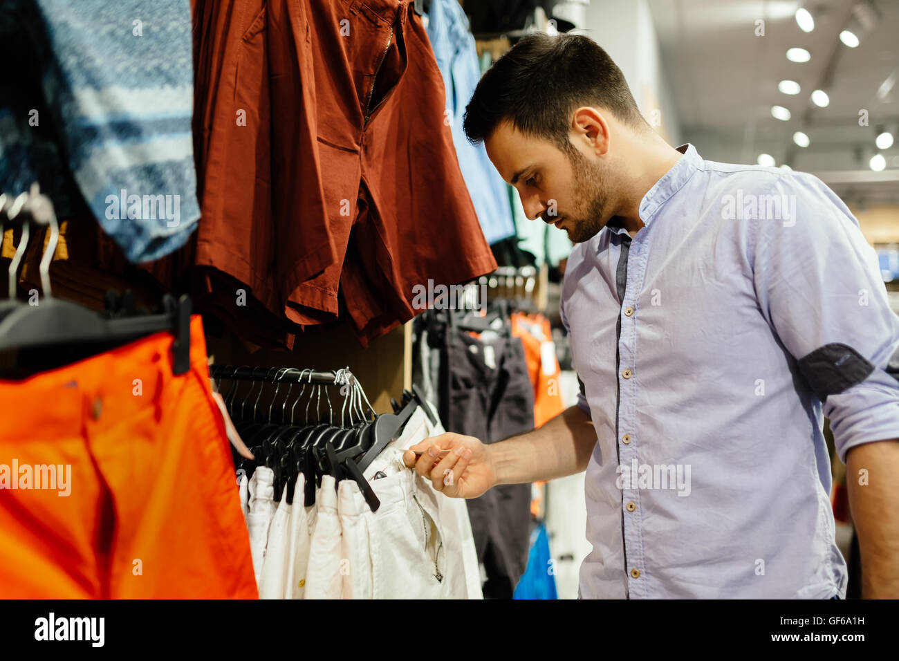 Handsome man buying new clothes Stock Photo Alamy
