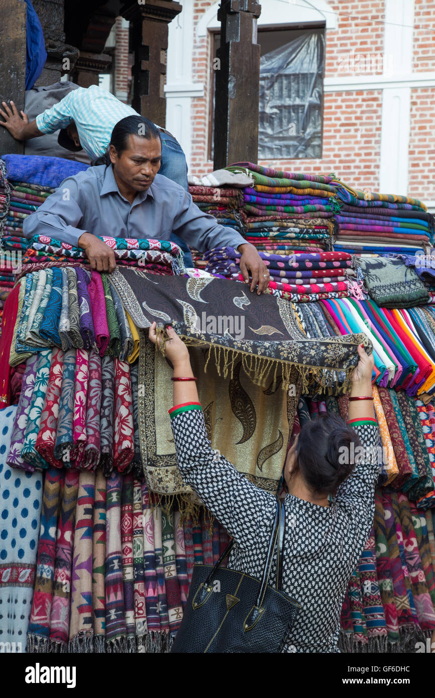 Kathmandu, Nepal - October 19, 2014: A seller showing scarfs to a customer on the market in Kathmandu, Nepal Stock Photo