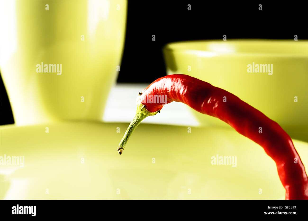 Red hot pepper on green dish over white wood. Horizontal image. Stock Photo