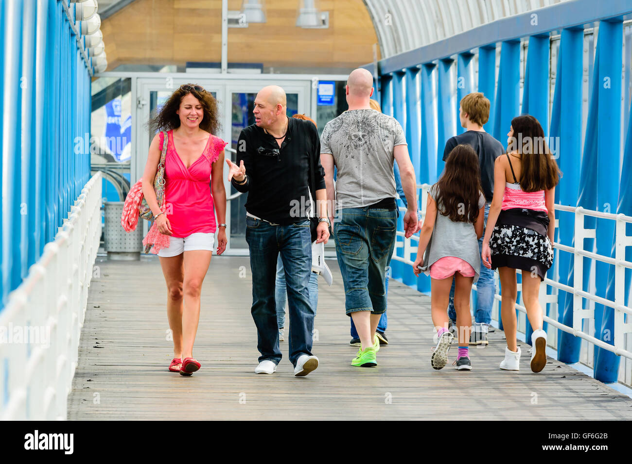 Goteborg, Sweden - July 25, 2016: Unknown people walking across an elevated public walkway. Attractive female and man walking to Stock Photo