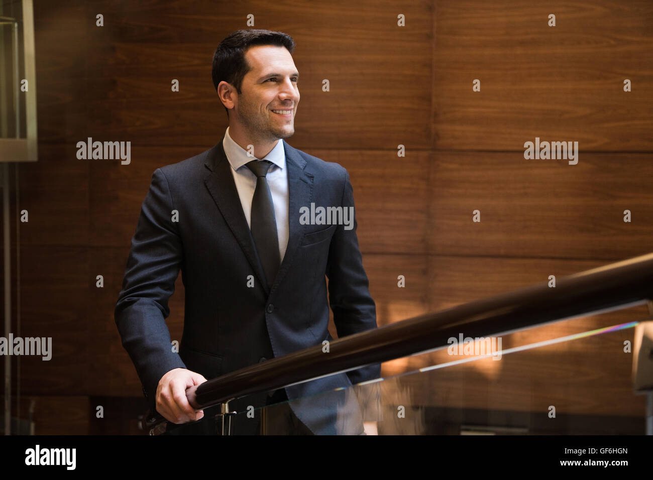 Businessman standing in hotel and looking away. Stock Photo