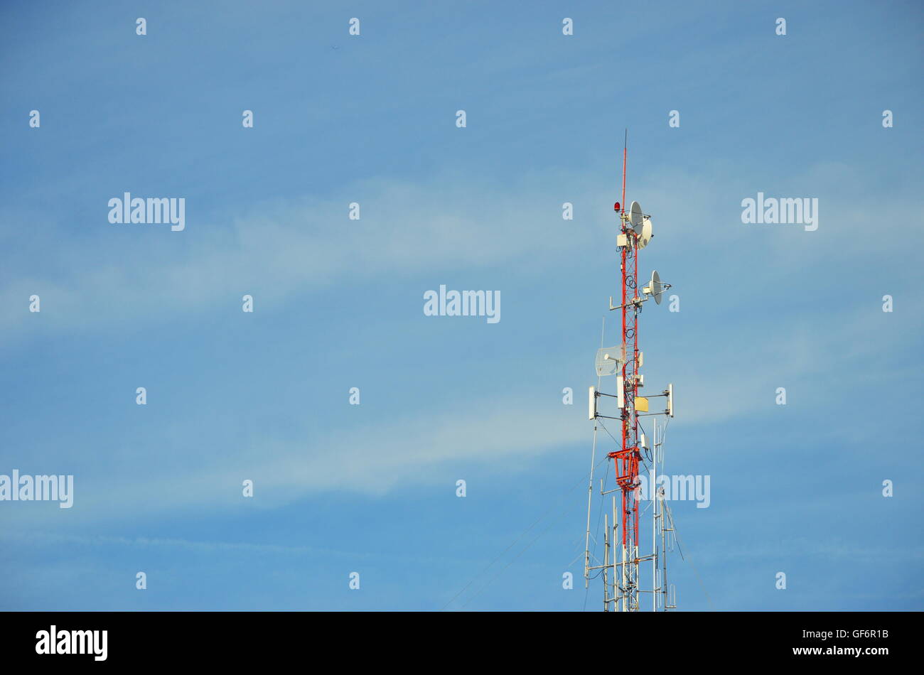 radio pole (telecommunication antenna) on blue sky and soft clouds background Stock Photo