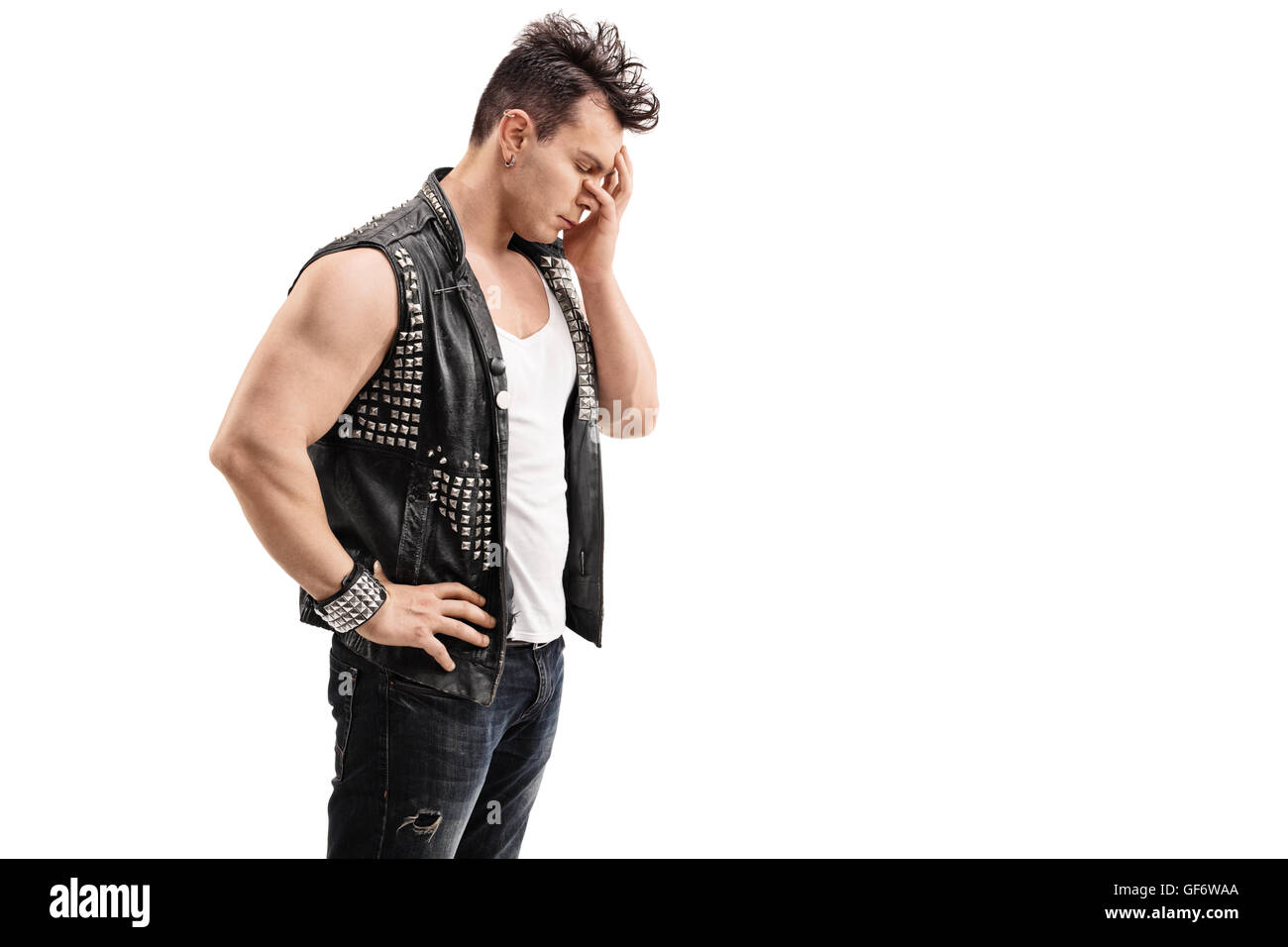 Disappointed young punk rocker holding his head in disbelief isolated on white background Stock Photo