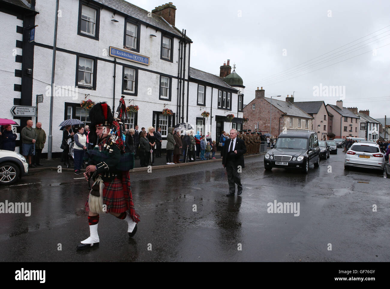 Crowds line the streets as the hearse carrying the body of Corporal Josh Hoole passes through his home town of Ecclefechan, near Lockerbie in Scotland before his funeral in Dumfries. Stock Photo