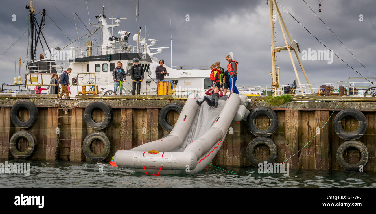 Teen on rescue slide at The Annual Seaman's Festival, Hafnarfjordur, Iceland Stock Photo