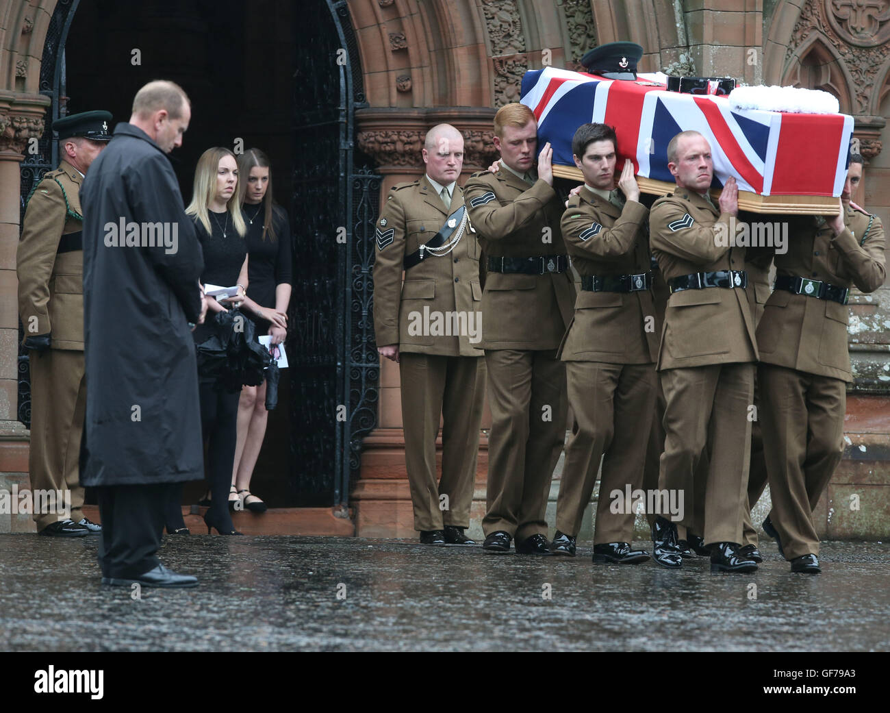 Fiancee Rachael McKie (right)follows the coffin as it is brought out from Crichton Memorial church in Dumfries after the funeral of Corporal Josh Hoole. Stock Photo
