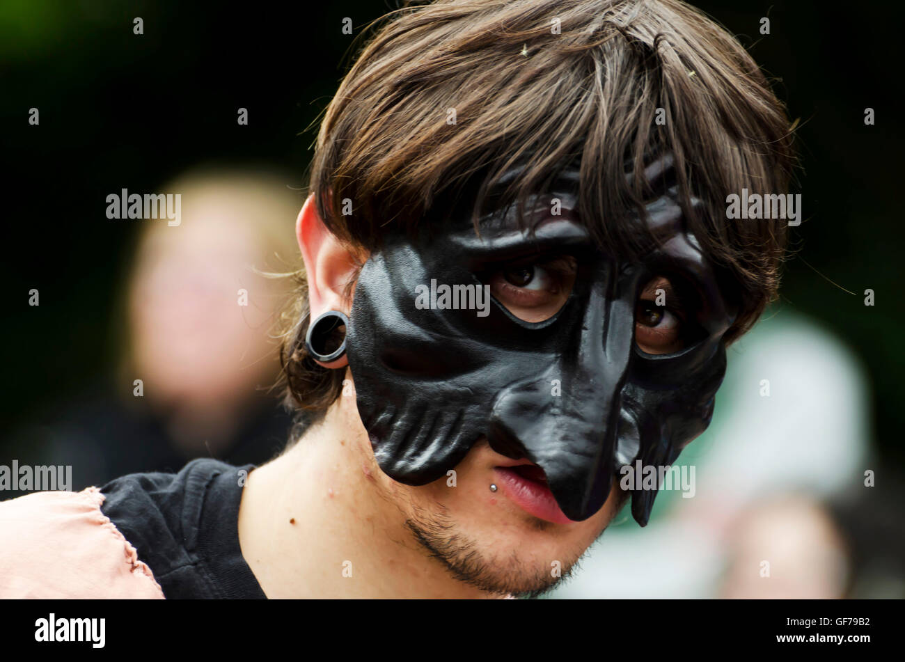Male dancer with a long-nosed mask taking part in the Carnival Parade, part of the Edinburgh Jazz Festival. Stock Photo