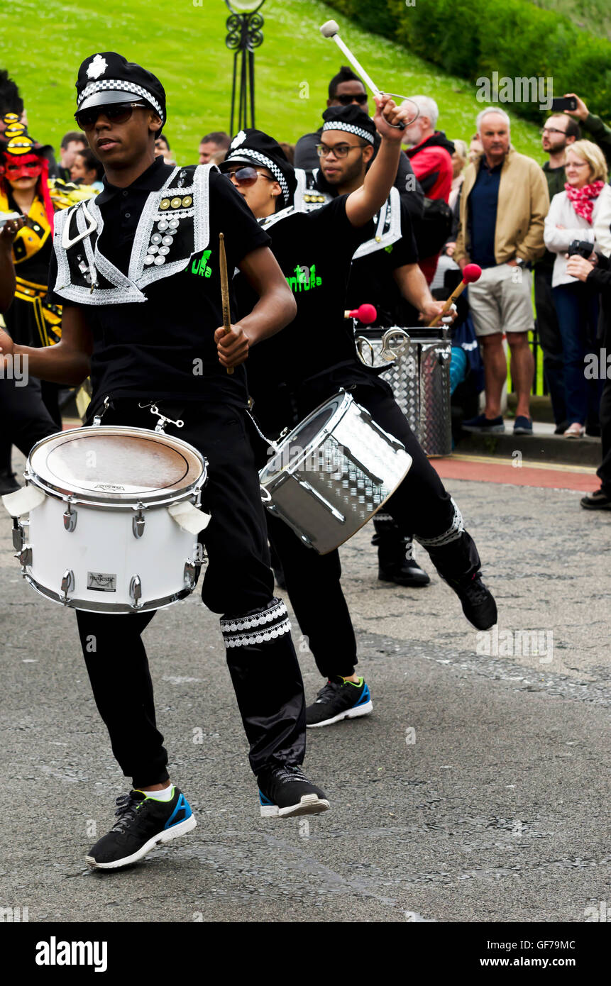 Drum and dance troupe dressed as American police taking part in the Carnival Parade, part of the Edinburgh Jazz Festival. Stock Photo