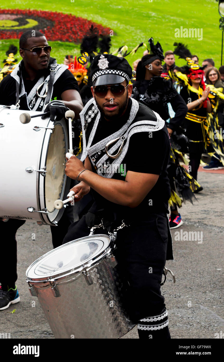 Drum and dance troupe dressed as American police taking part in the Carnival Parade, part of the Edinburgh Jazz Festival. Stock Photo