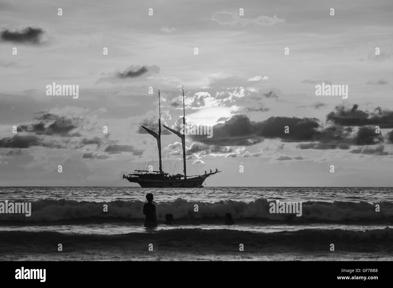 Dramatic sea and transport boat with sunset in over light the sun black and white tone Stock Photo