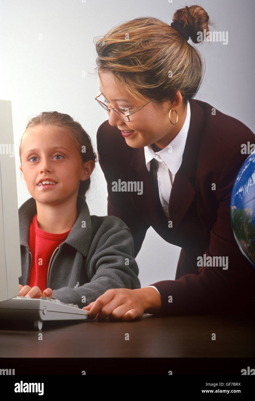 student and teacher with computer Stock Photo