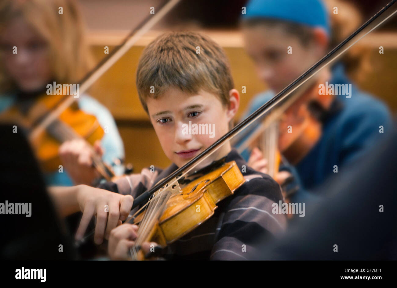 boy playing viola in orchestra Stock Photo