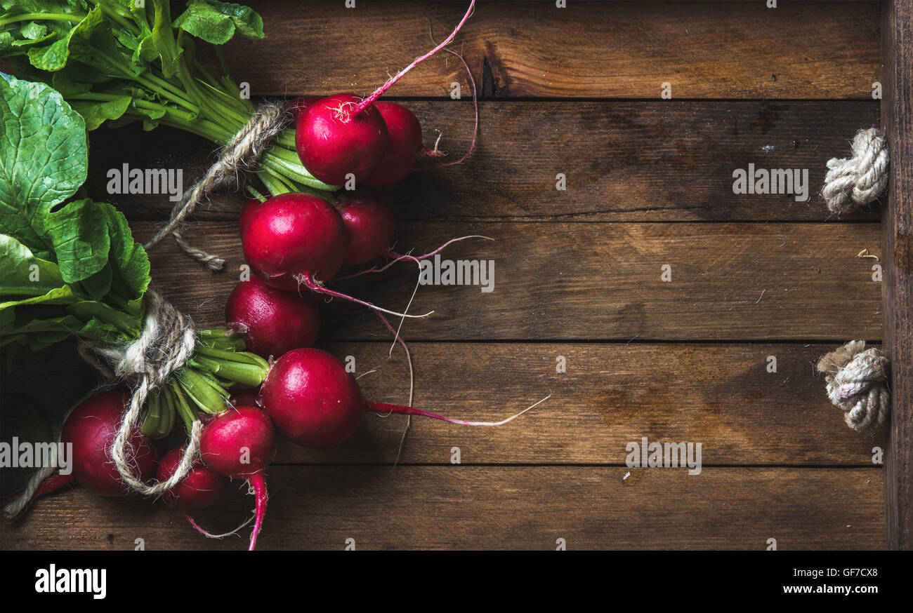 Fresh radish banches on wooden tray background, copy space Stock Photo