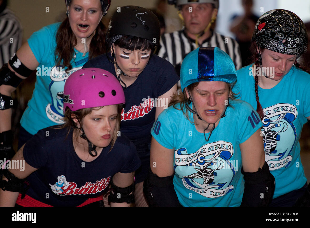 Women roller derby skaters line up at the start of a jam Stock Photo
