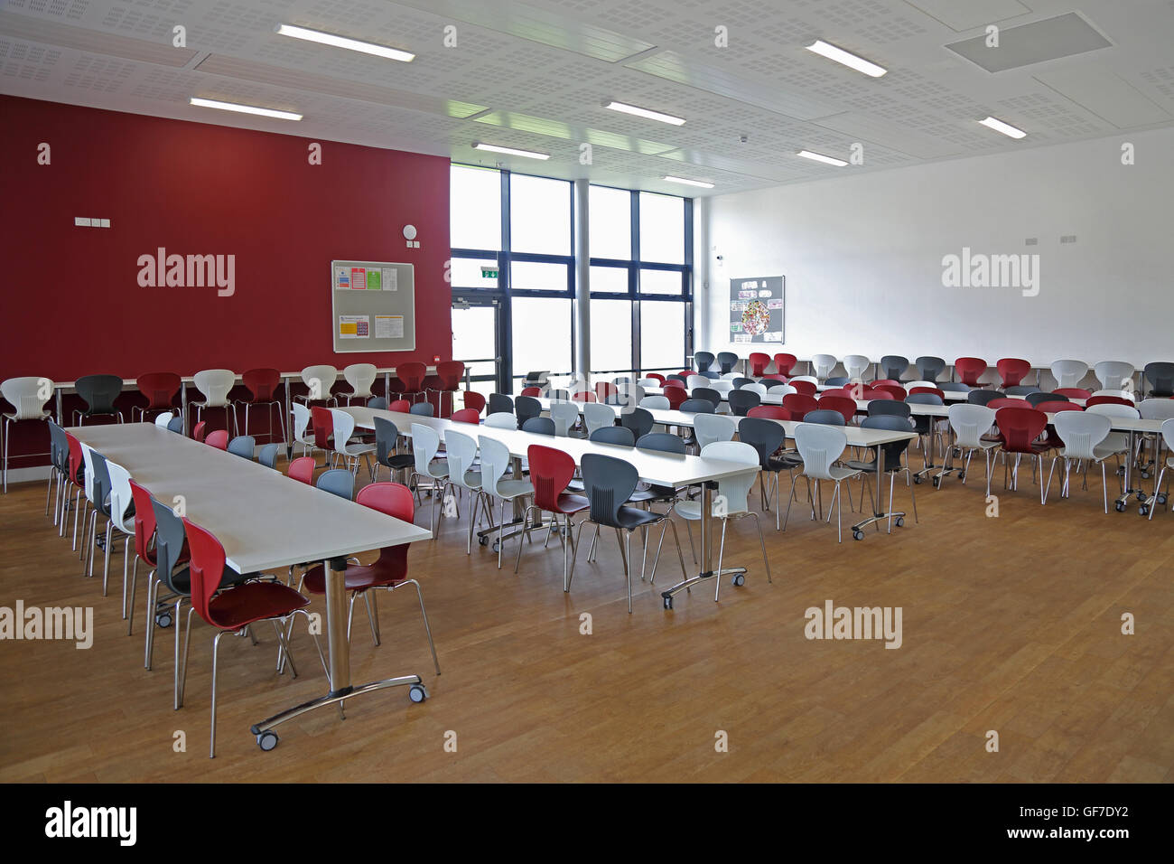 Interior view of a new school dining hall. Shows tables and chairs, no people. Stock Photo