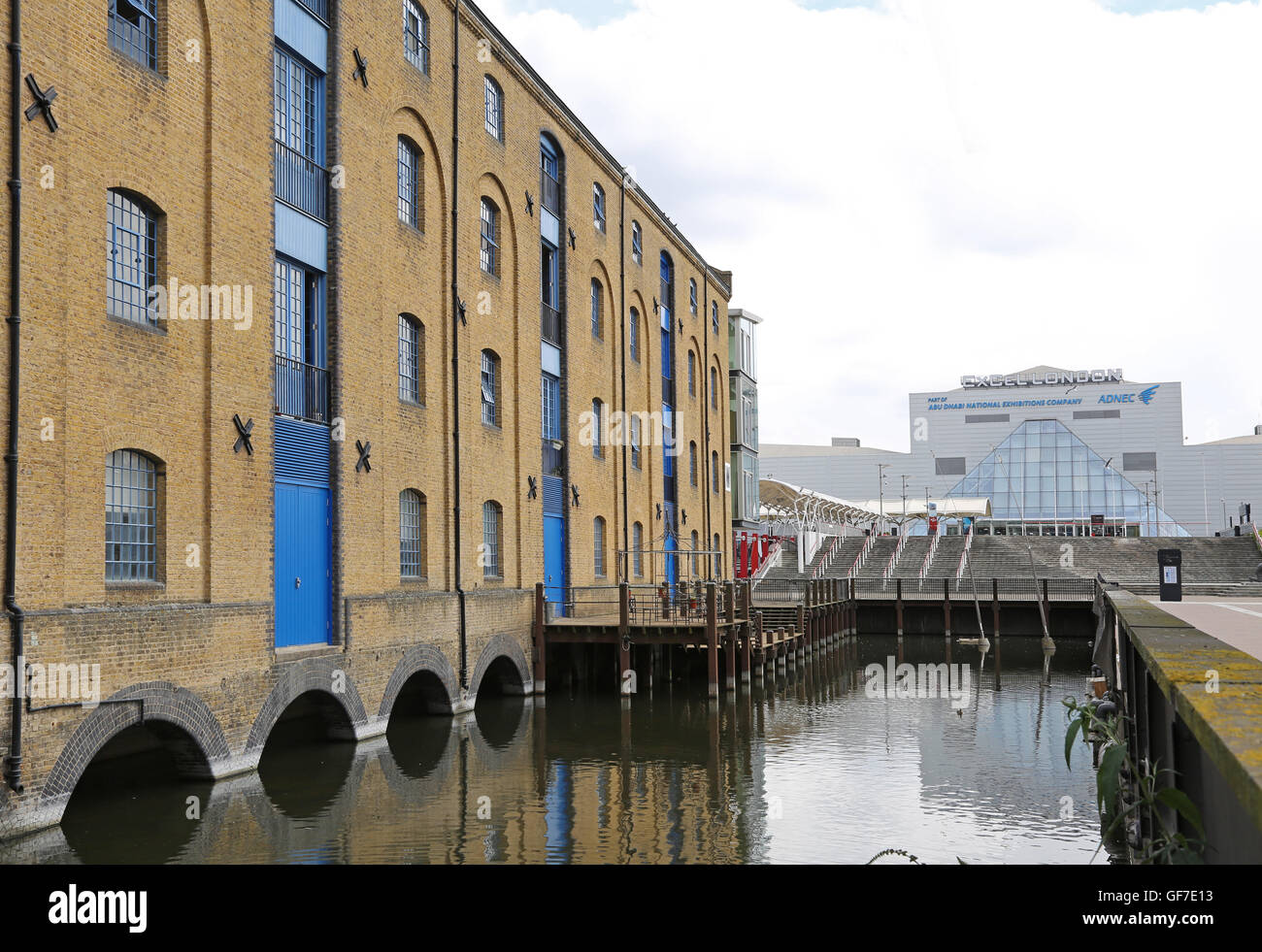 Converted Victorian warehouses at London's Royal Victoria Dock, next to the new Excel Exhibition Centre - seen to the right Stock Photo