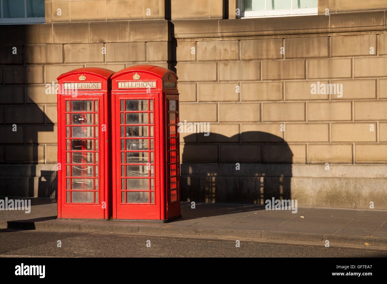 Two old red British telephone boxes in Edinburgh. Stock Photo
