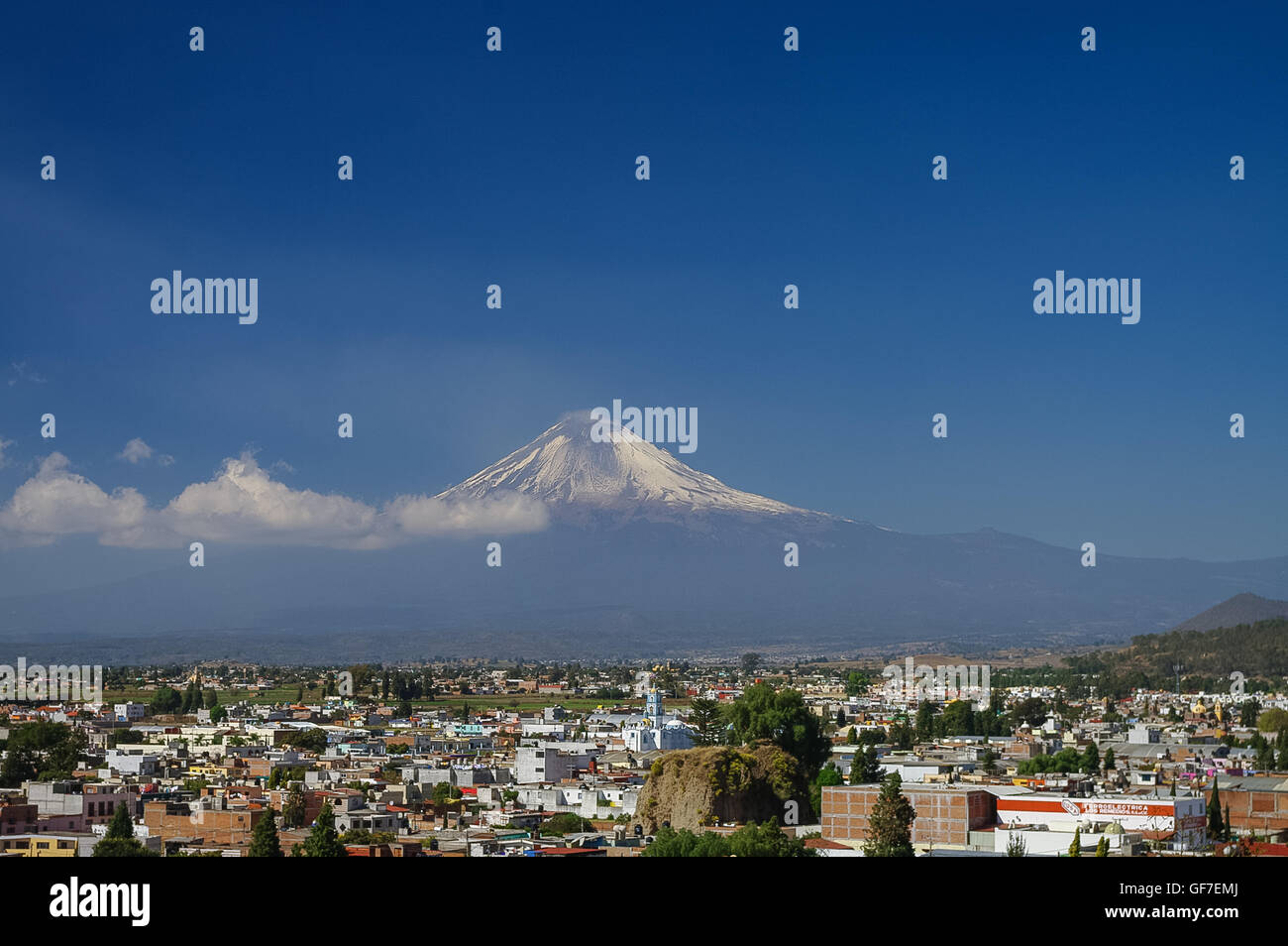 Popocatepetl Volcano Towering over the town of Puebla, Mexico Stock Photo