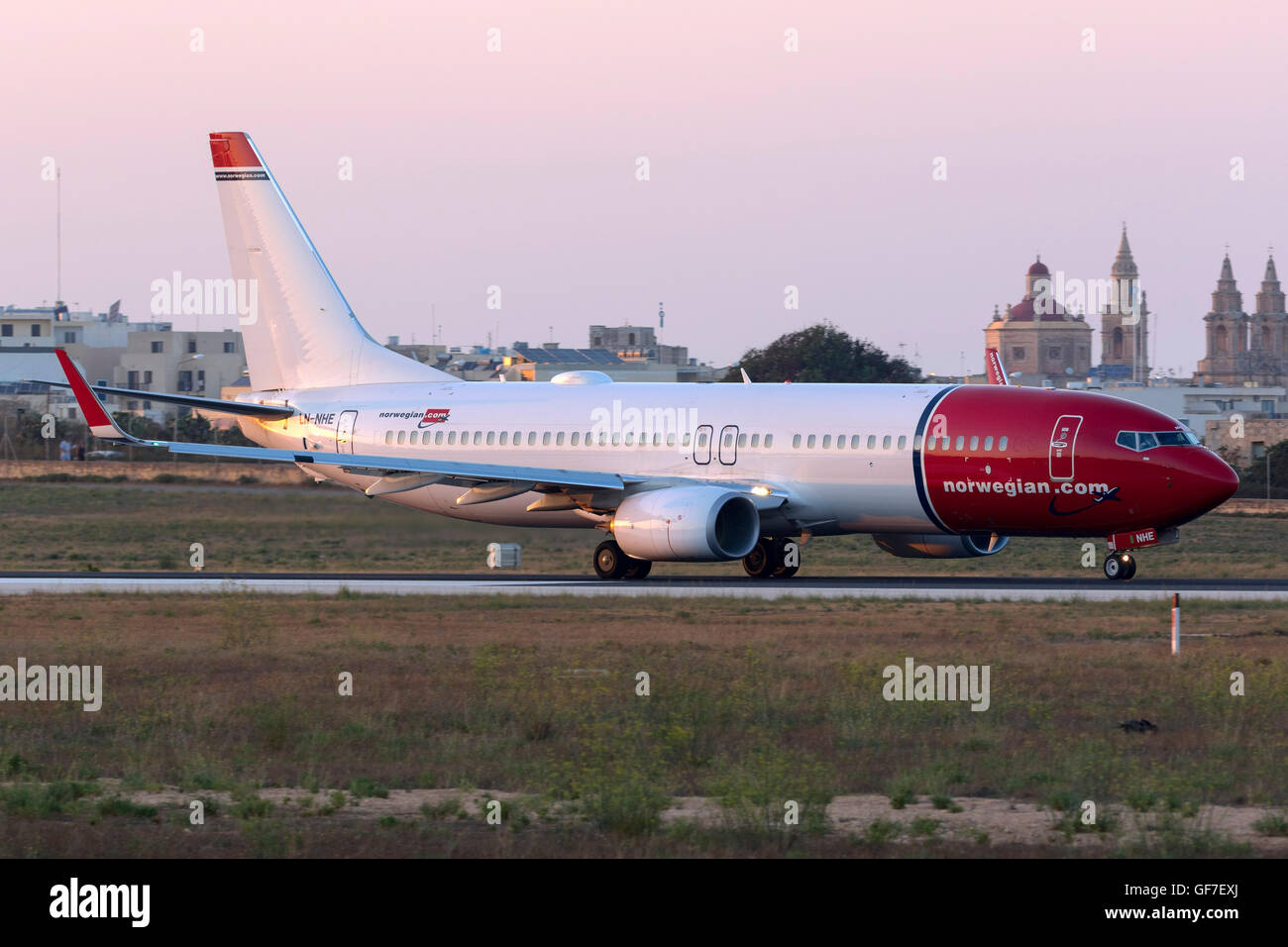 Norwegian Air Shuttle Boeing 737-8JP [LN-NHE] lining up runway 31 for take off during sunset. Stock Photo