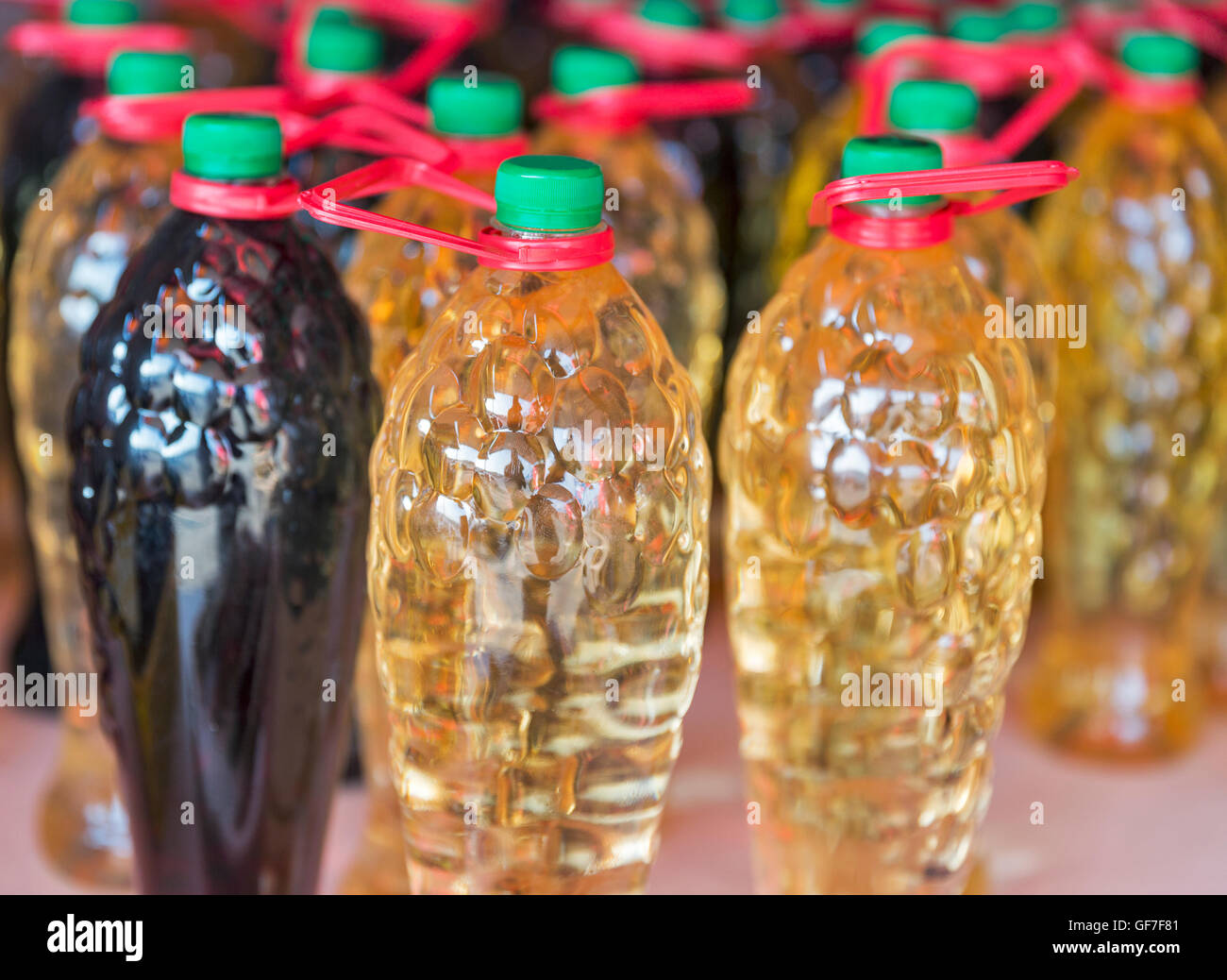 home brewed wine in plastic bottles on sale in street market closeup