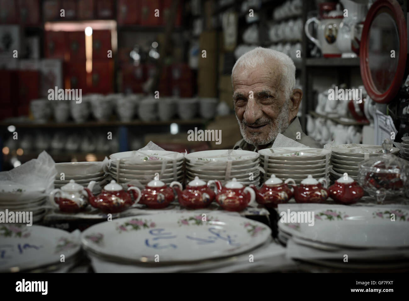 Porcelain shop keeper around Kashan Main bazaar, Iran. Stock Photo