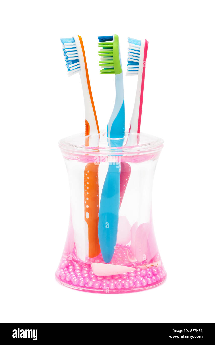 three new toothbrushes on a white background Stock Photo - Alamy