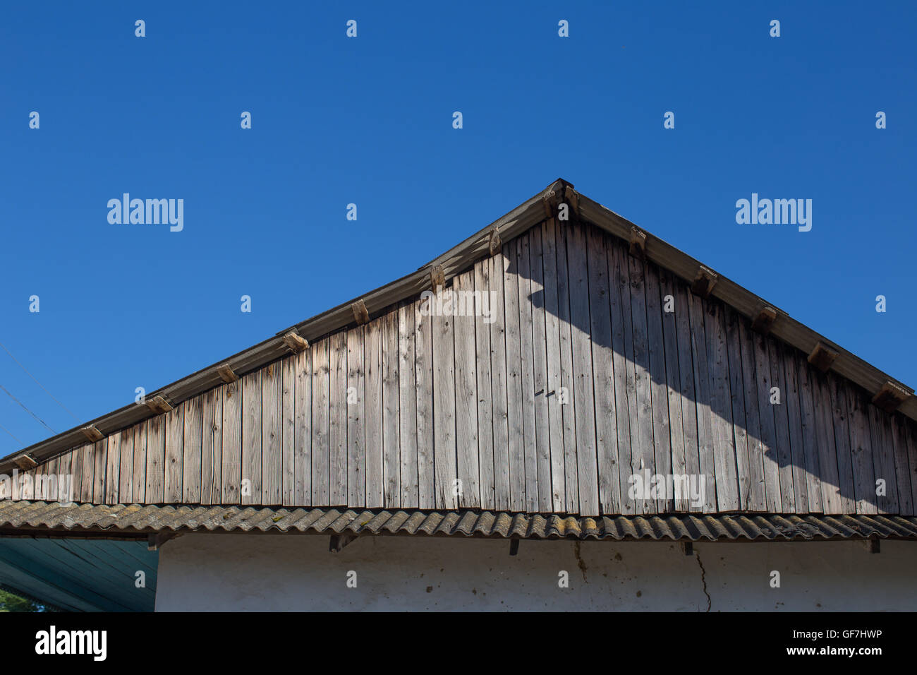 Old house wooden roof and blue sky Stock Photo - Alamy