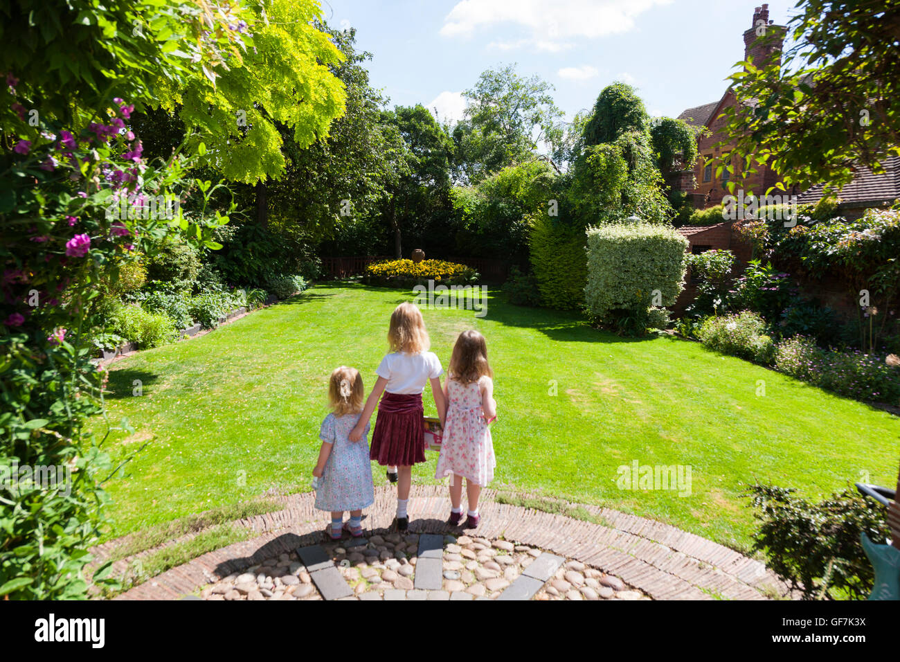 Greyfriars' House and Gardens with 3 children / kids / kid about to run & play on the garden lawn grass. Friar St, Worcester. UK Stock Photo