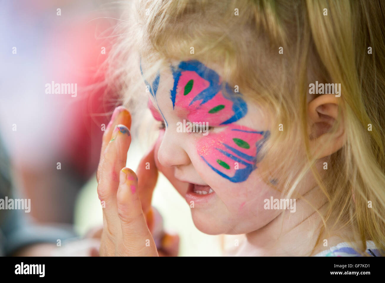 Professional face painting make up / makeup artist paints a six year