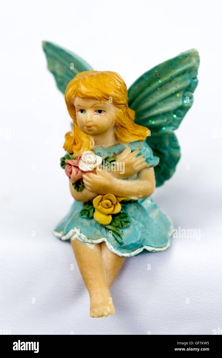 Fairy model figurine with wings sitting on an isolated white background. Stock Photo