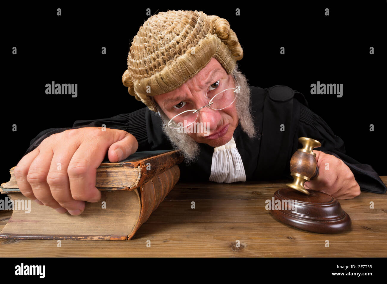 Angry judge in extreme wide angle closeup with hammer and wig Stock