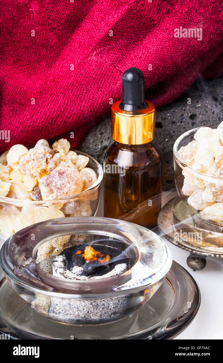 Bottle with organic essential aroma oil from Frankincense tree (Boswellia sacra) tree resin and Frankincense insence. Stock Photo