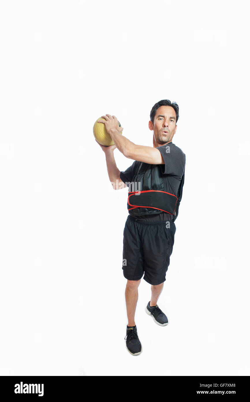 Middle age man showing wood chop exercise in weighted vest. Stock Photo
