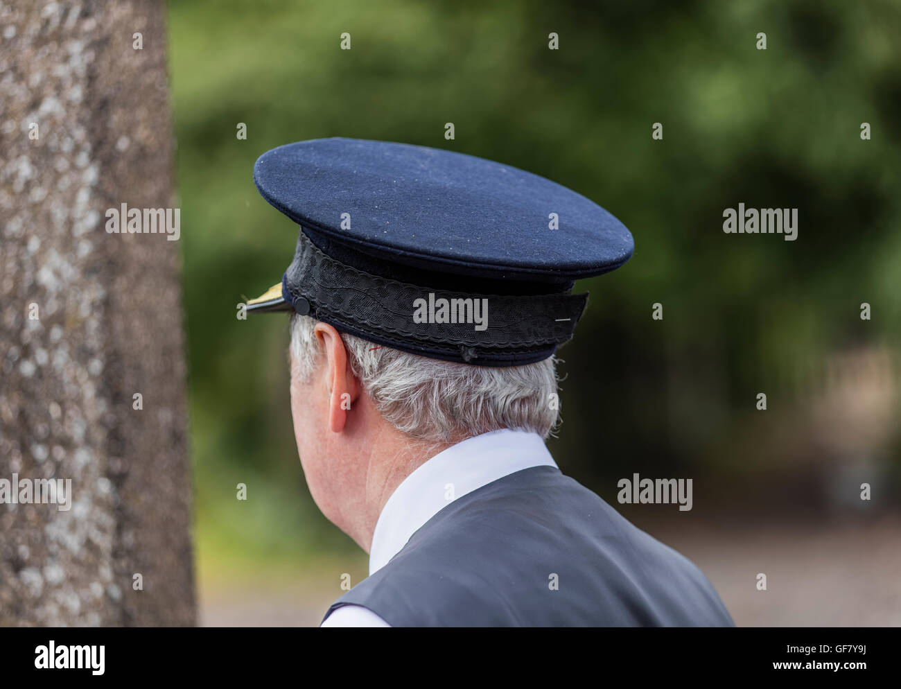 Rear of volunteeer train guard with close up image of the cap at the Didcot Railway Centre in Oxfordshire Stock Photo