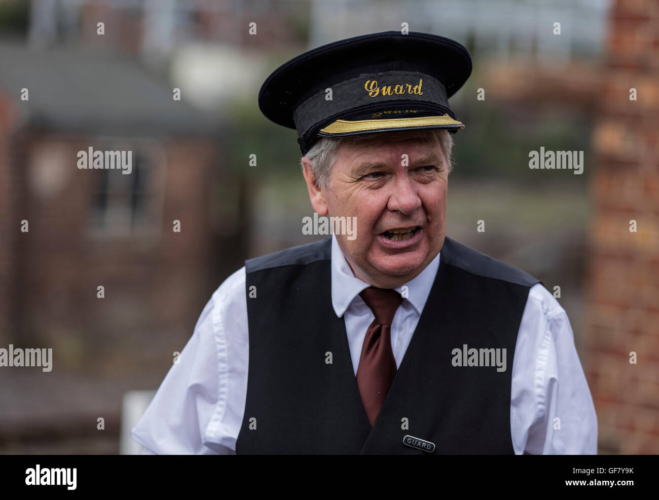 Volunteer train guard dressed in authentic uniform of the day at the
