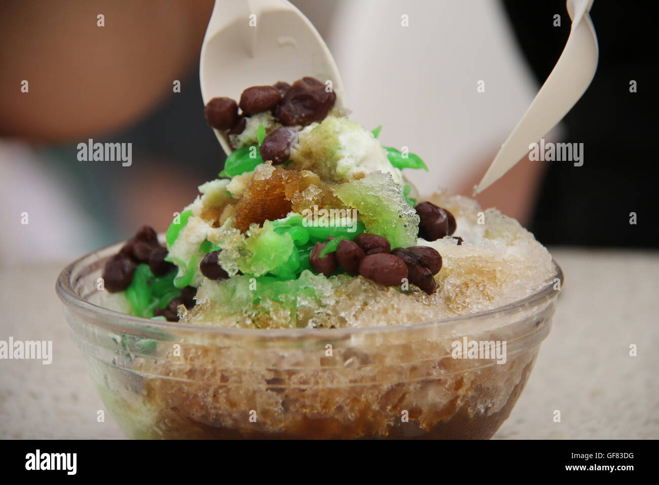 Ice Kacang (shaved ice with red bean) being mixed ready to be consumed. Stock Photo