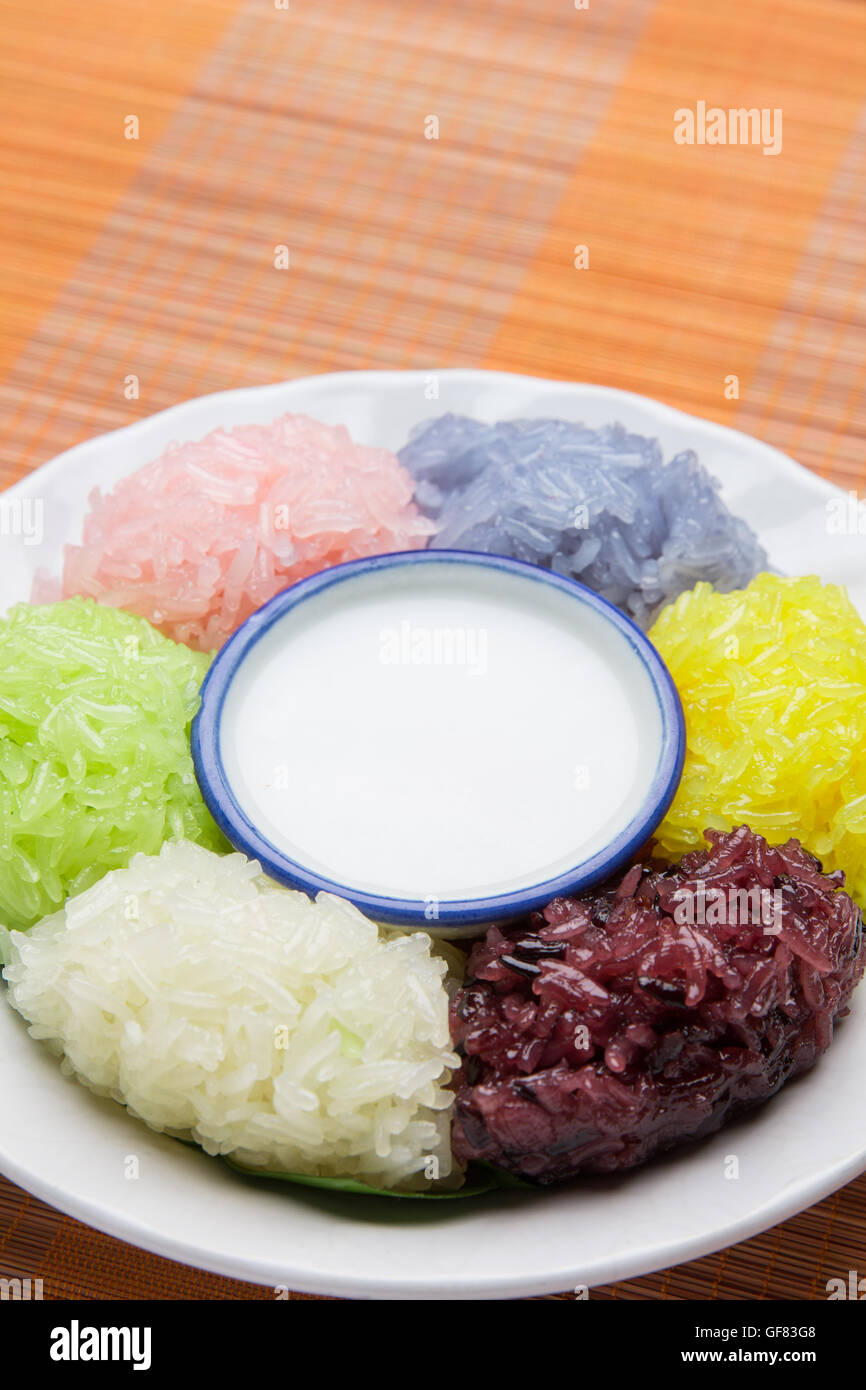 dessert sweet sticky rice with coconut milk in plate on wood pattern background Stock Photo