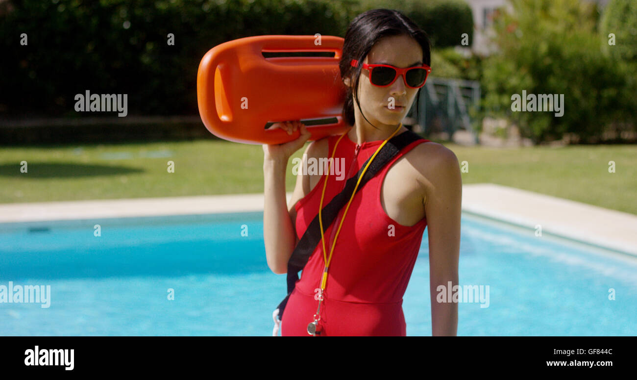 Serious lifeguard holding floatation device Stock Photo Alamy