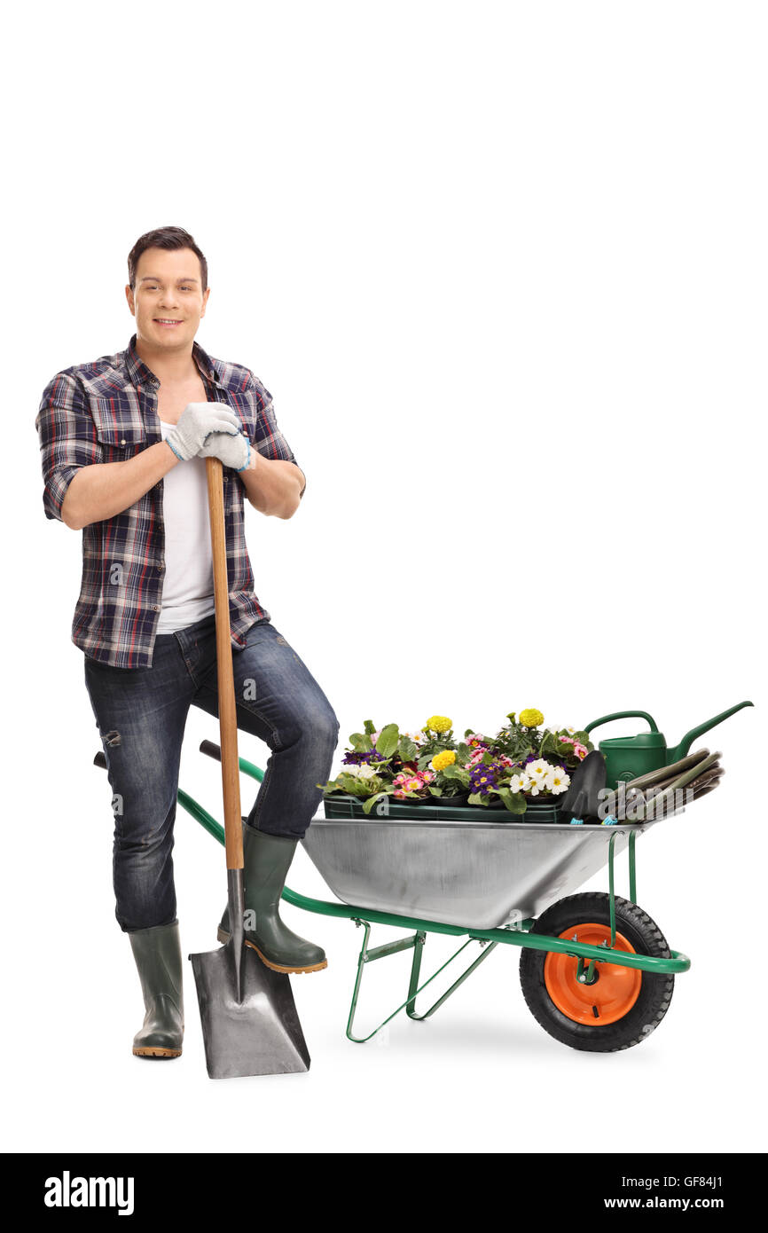 Full length portrait of a cheerful gardener posing with gardening equipment isolated on white background Stock Photo