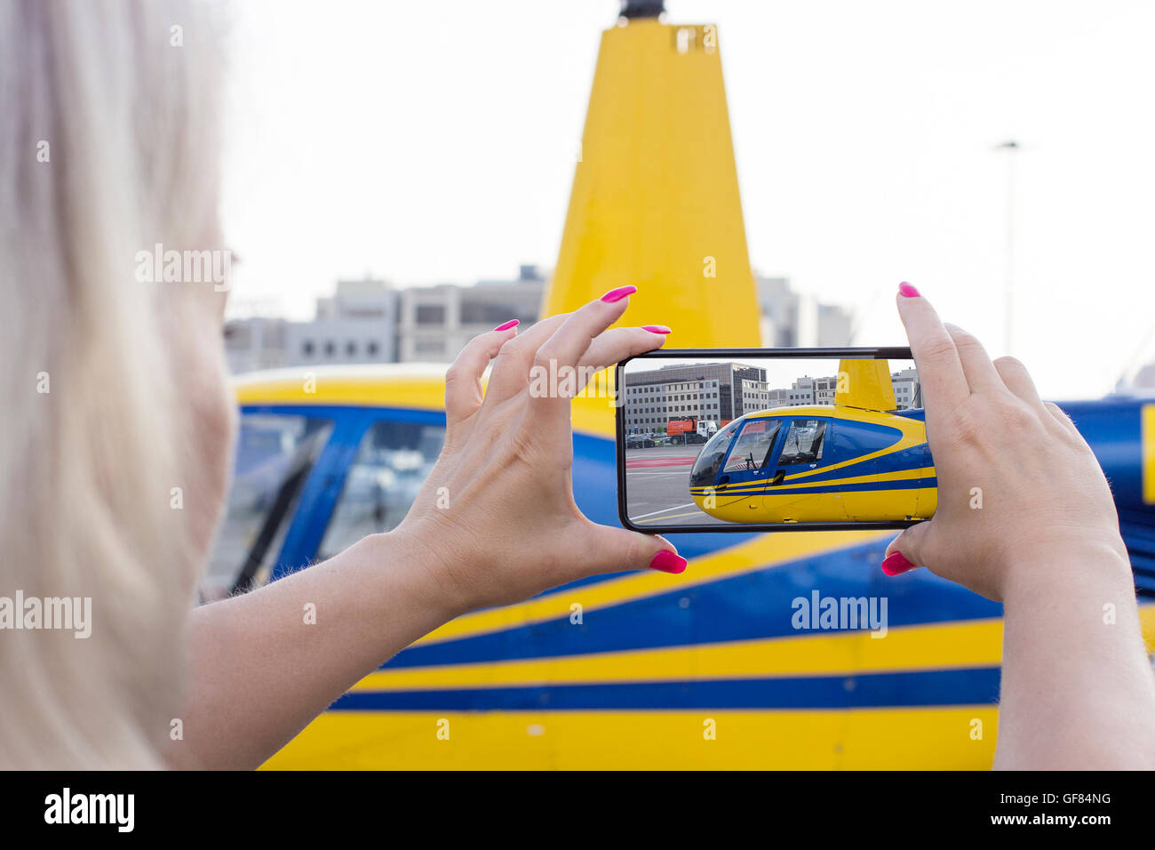 Woman making helicopter photo by smart phone Stock Photo